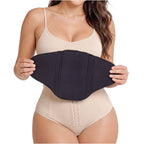 Fajas Salome 2516NEU black waist cincher compression belt held by woman wearing nude body shaper Colombian shapewear front vi